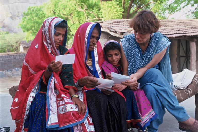 Ilse Köhler-Rollefson sits with a Raika woman and her daughters. Raika society is usually closed to outsiders.